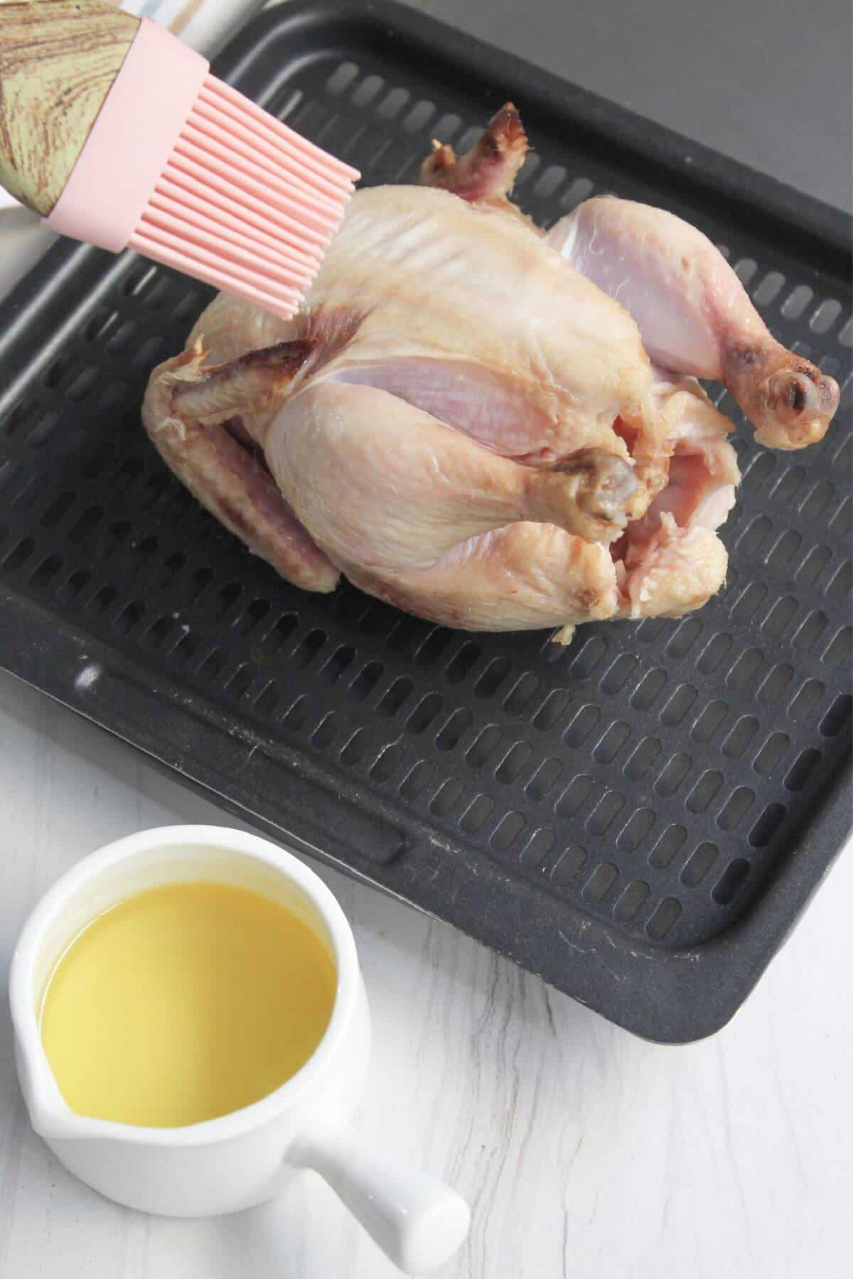 Seasoned cornish hen brushed with oil.