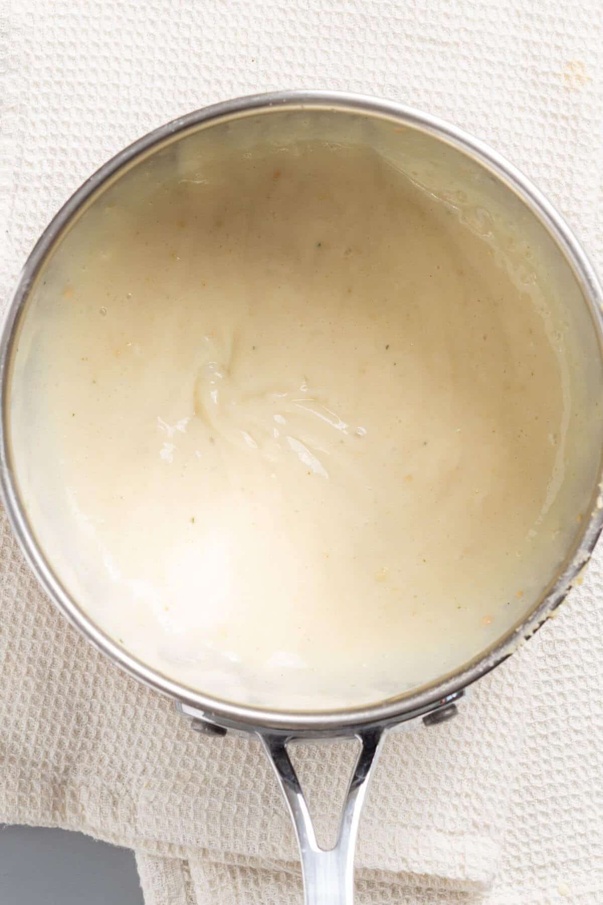 Thickened sauce mixture in skillet.