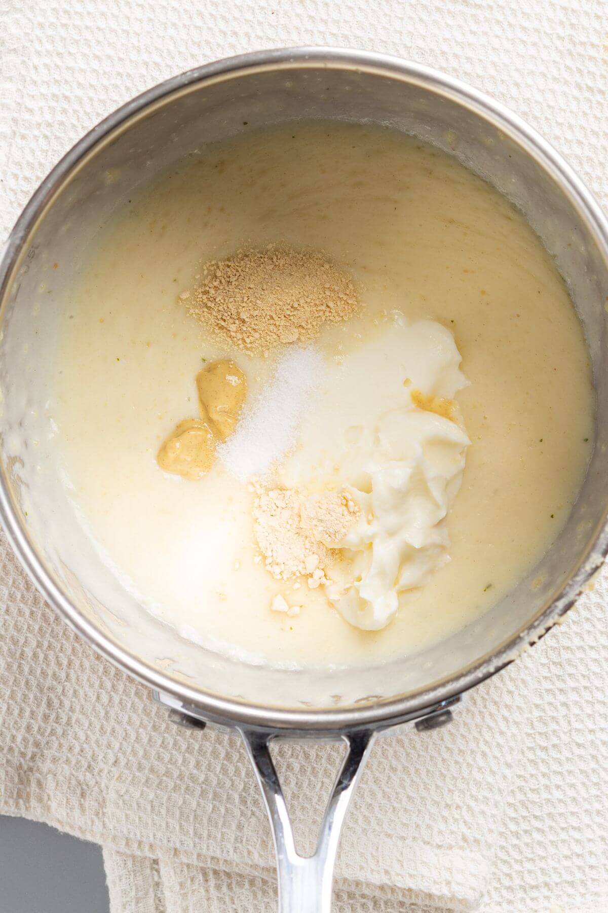 Sour cream Dijon mustard, salt, garlic and onion powder added to sauce in skillet.