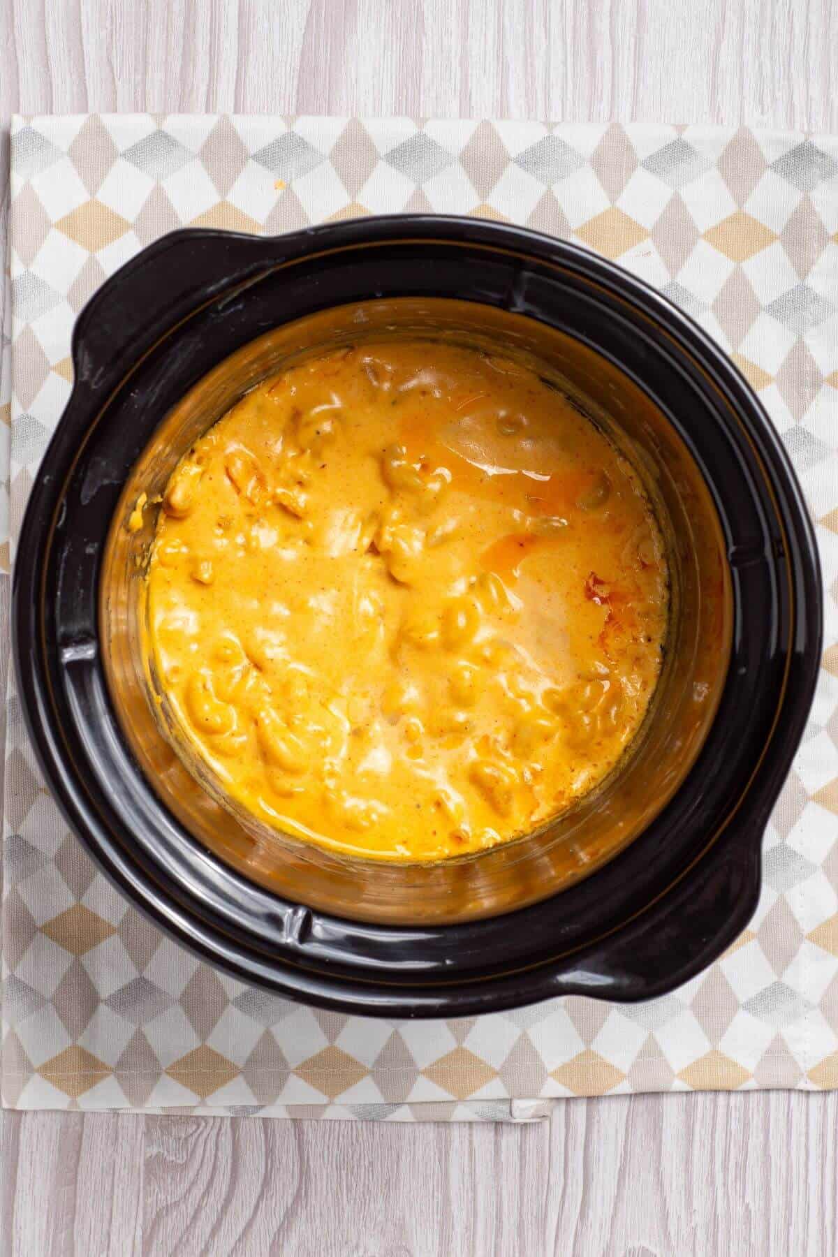 A crock pot full of macaroni and cheese.