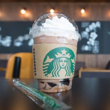 A secret menu Starbucks drink topped with whipped cream and served with a straw.