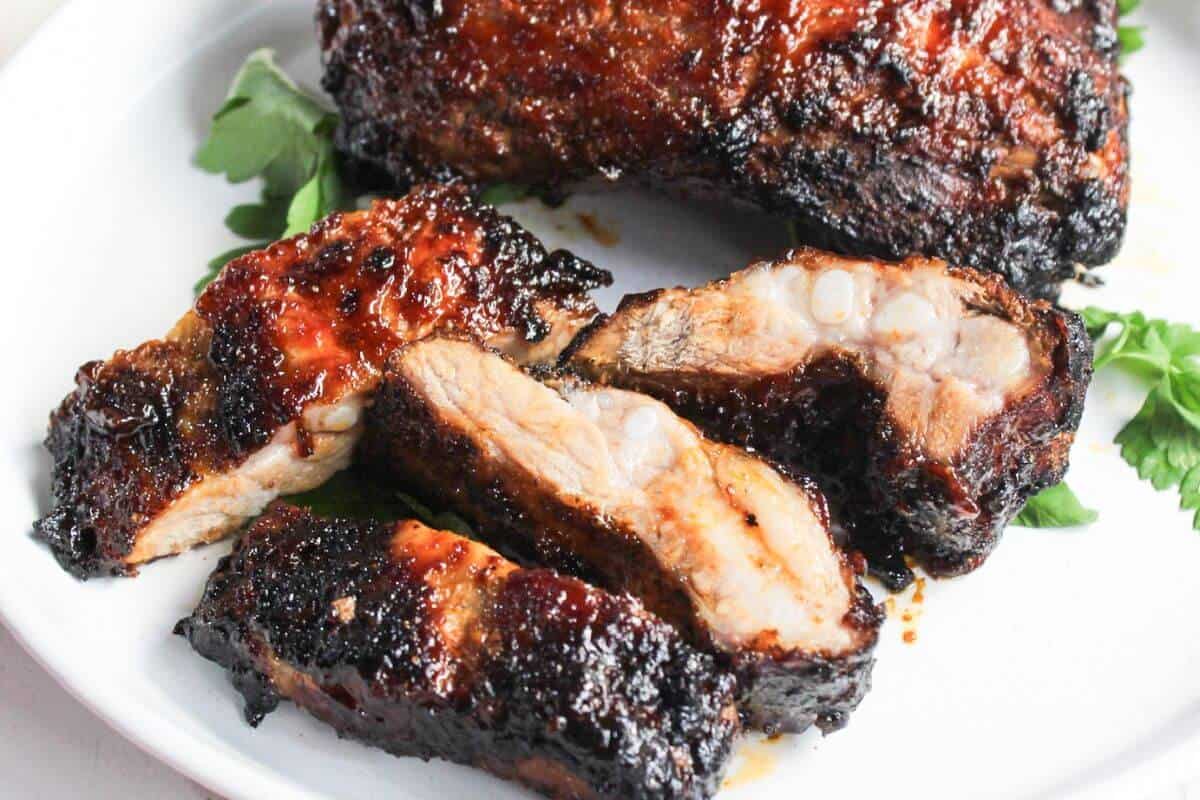 BBQ ribs on a white plate.