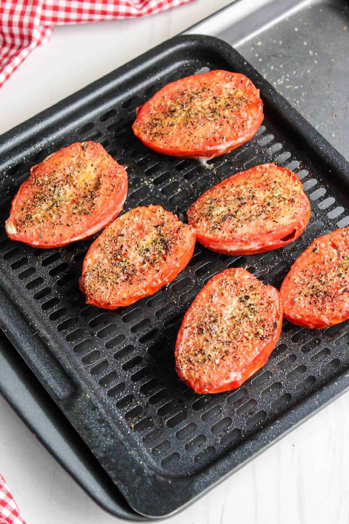 Tomatoes on an air fryer tray.