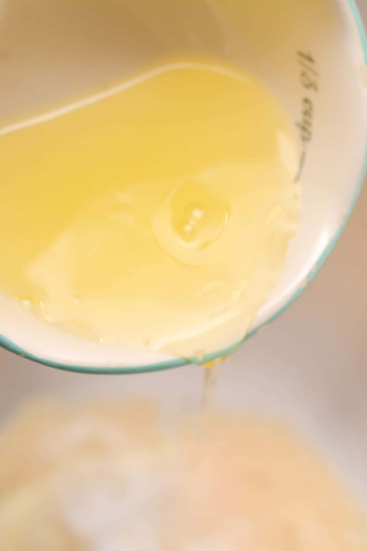 Egg white is being poured into a bowl.