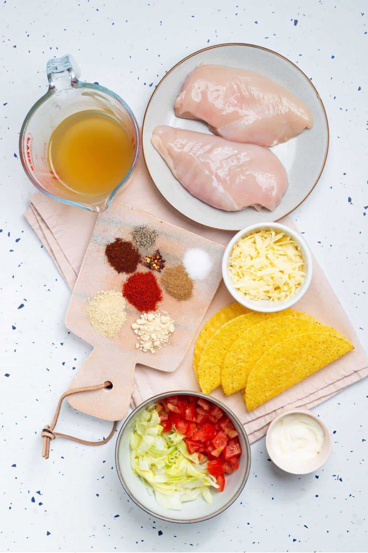 Chicken taco ingredients on a white table.