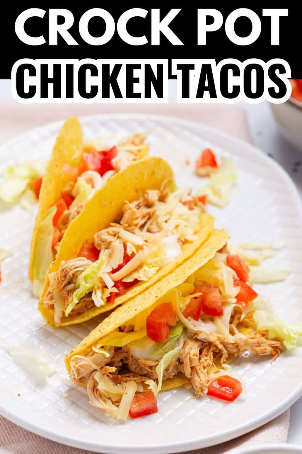 Crock pot chicken tacos on a white plate.