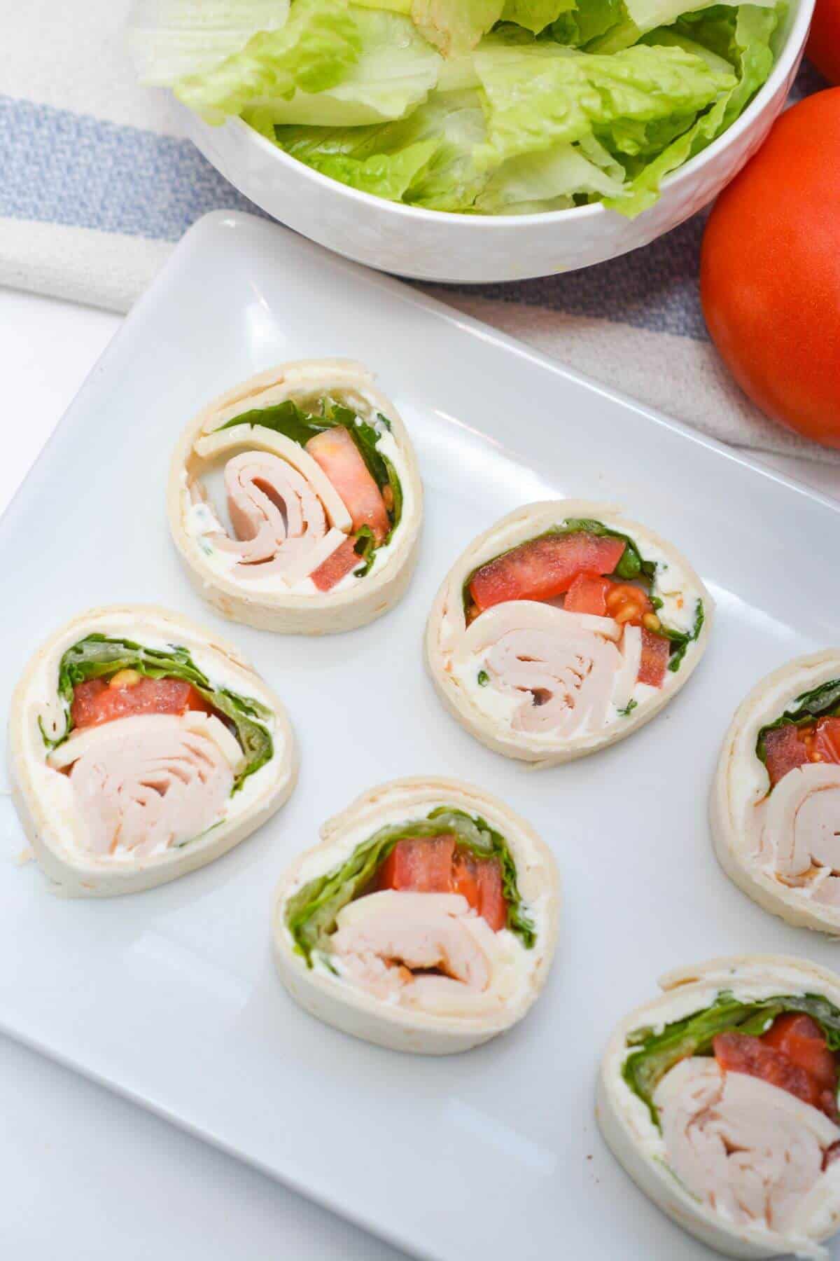 A white plate with a tray of mini turkey and tomato tarts.