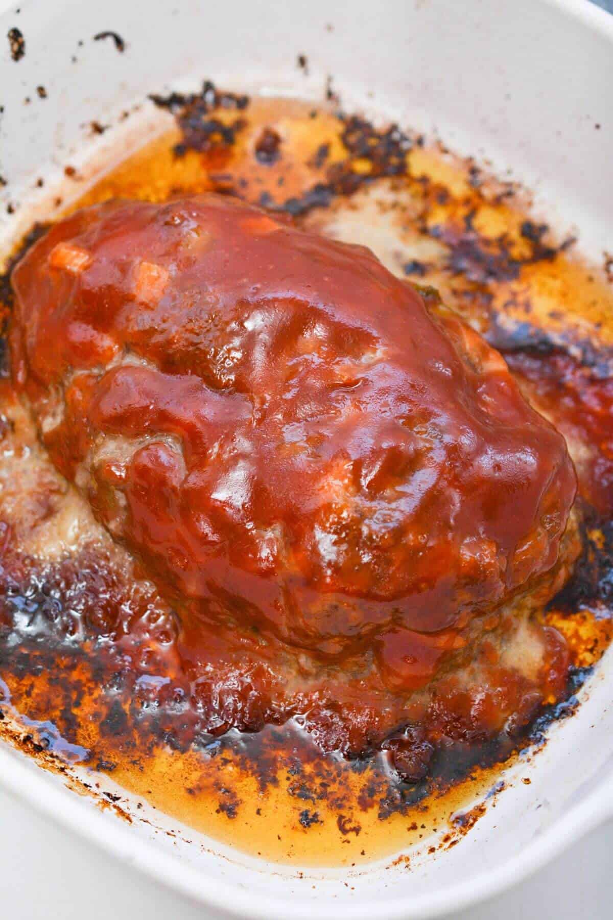Meatloaf in a baking dish with sauce.