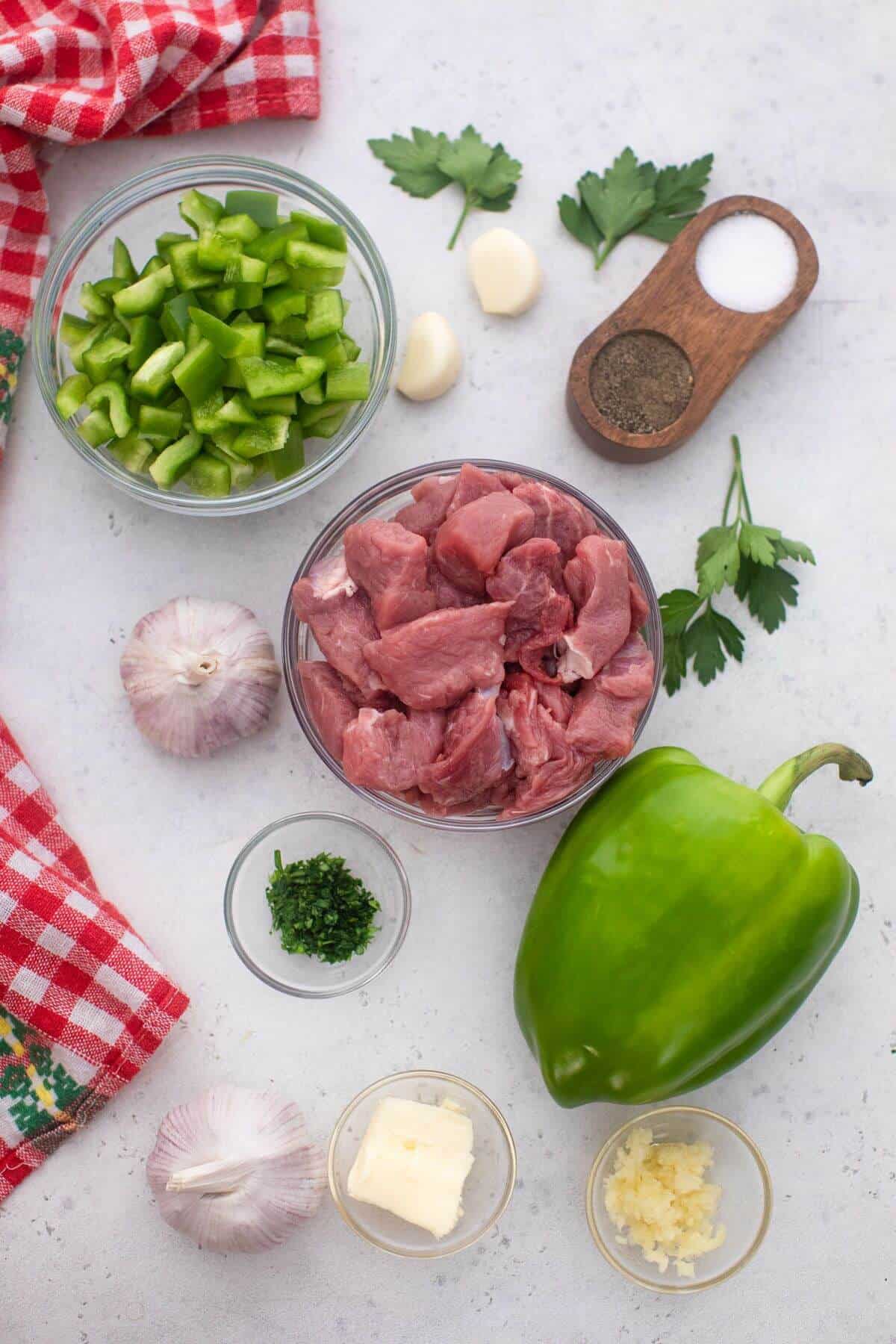 Ingredients for garlic butter steak bites on a white background.