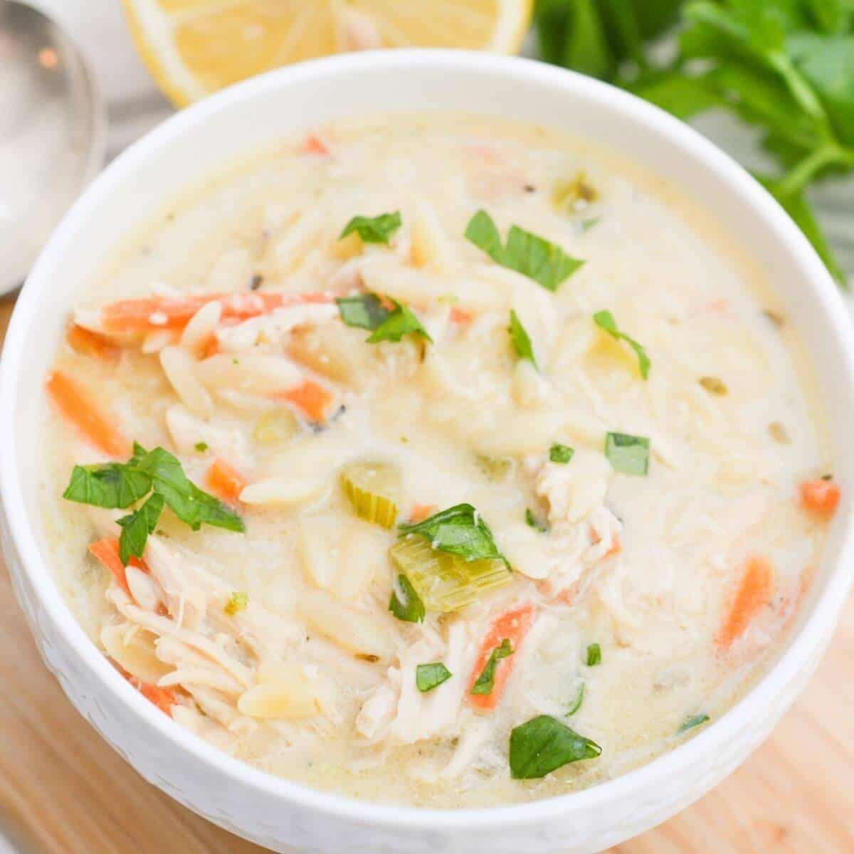 Greek lemon chicken soup in a white bowl.