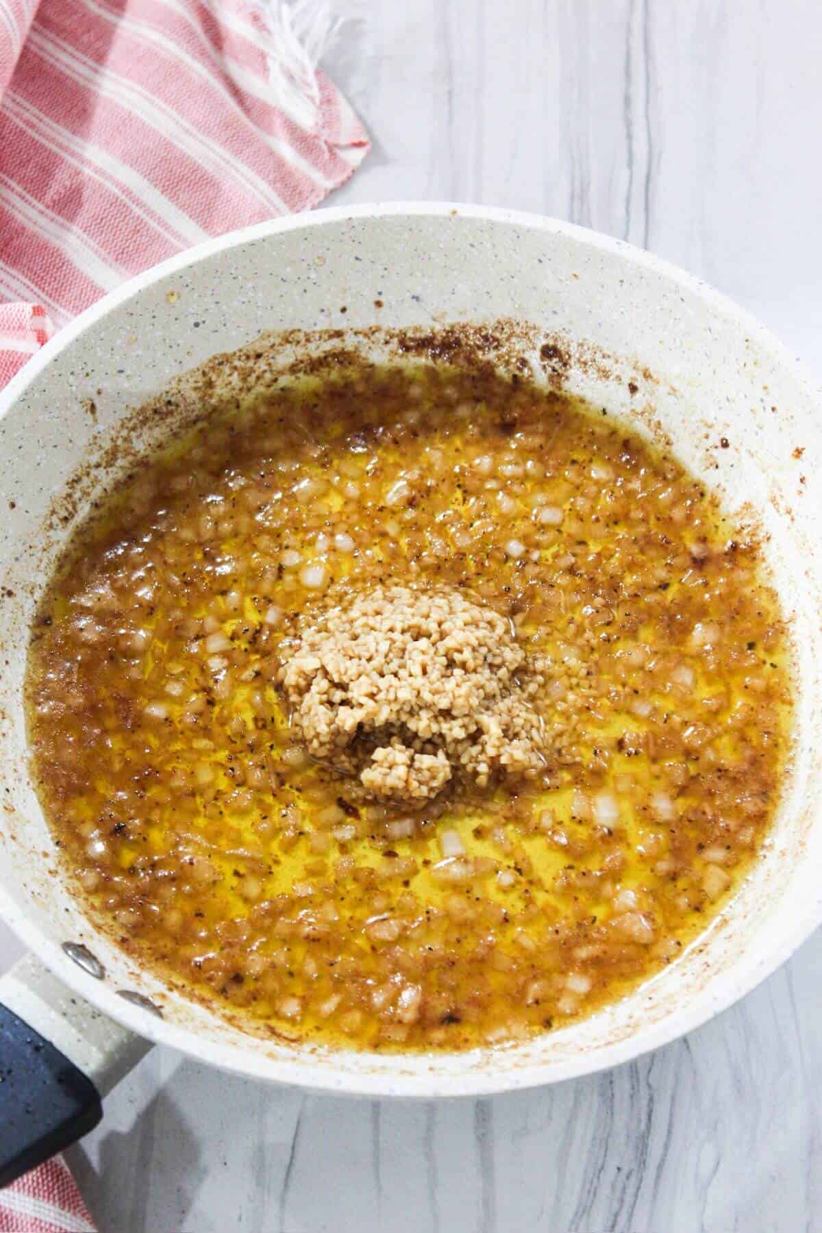A frying pan with a mixture of brown sugar and cinnamon.