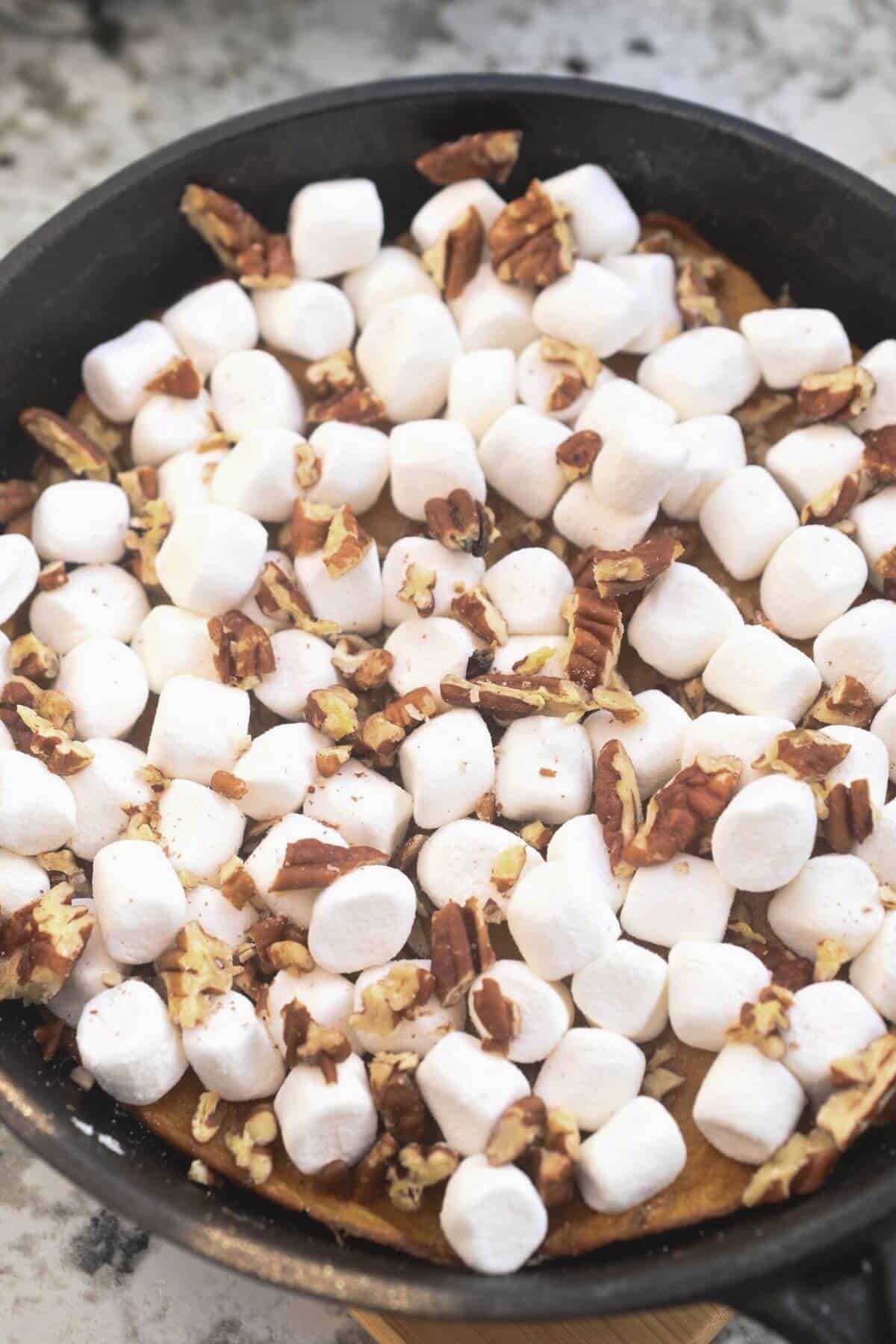 A sweet potato casserole with canned yams topped with marshmallows and pecans.