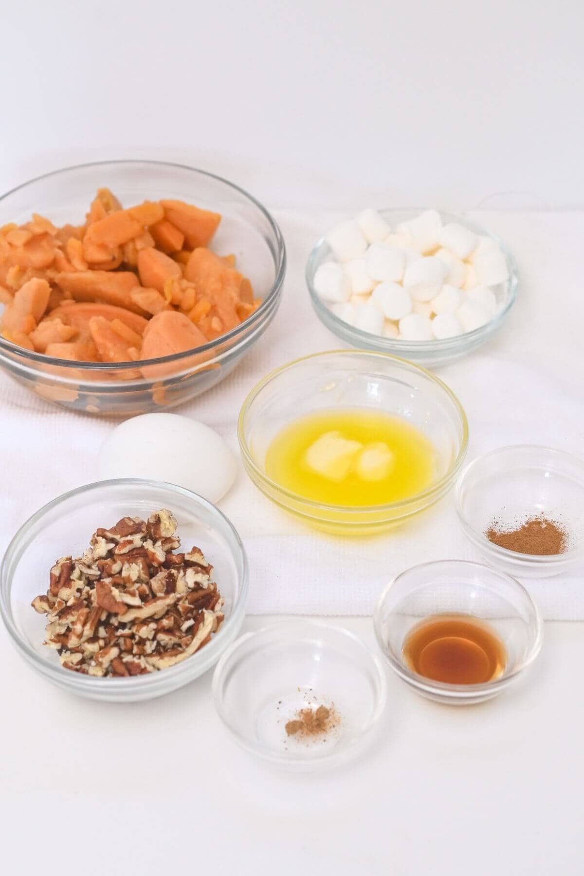 A tabletop with sweet potato casserole ingredients.