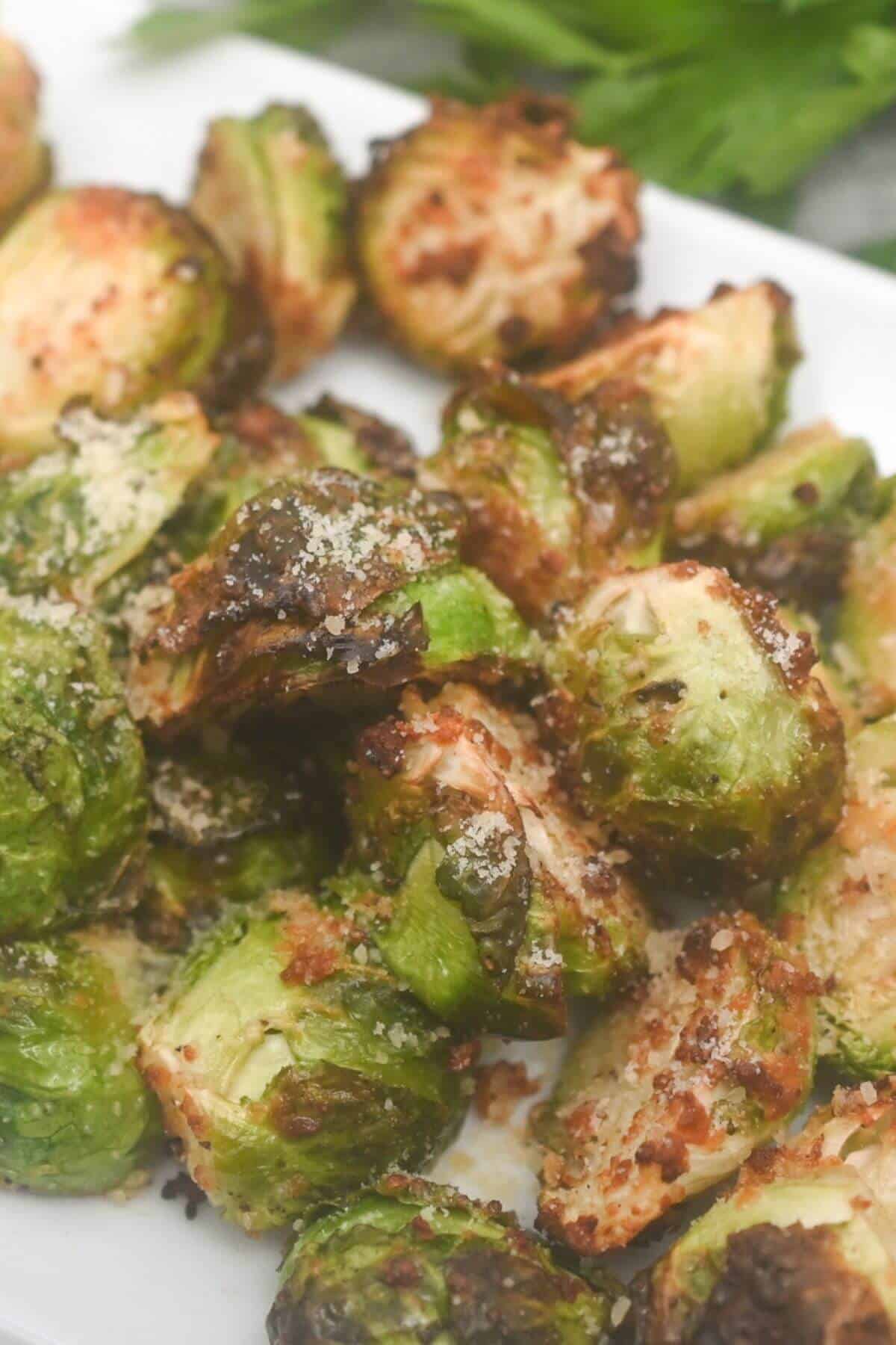 Roasted brussels sprouts on a white plate.