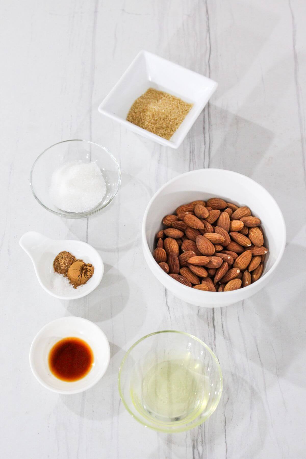 Ingredients for candied almonds on a marble table.