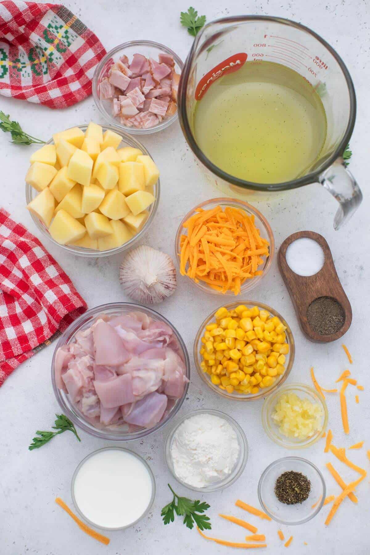 Ingredients for chicken chowder soup on a white background.