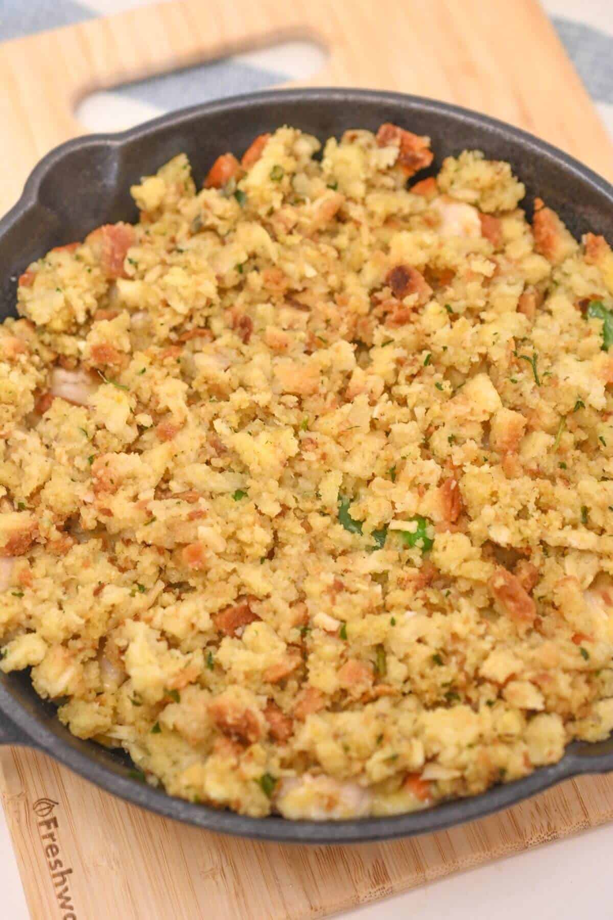 A chicken and stuffing casserole on top of a cutting board.