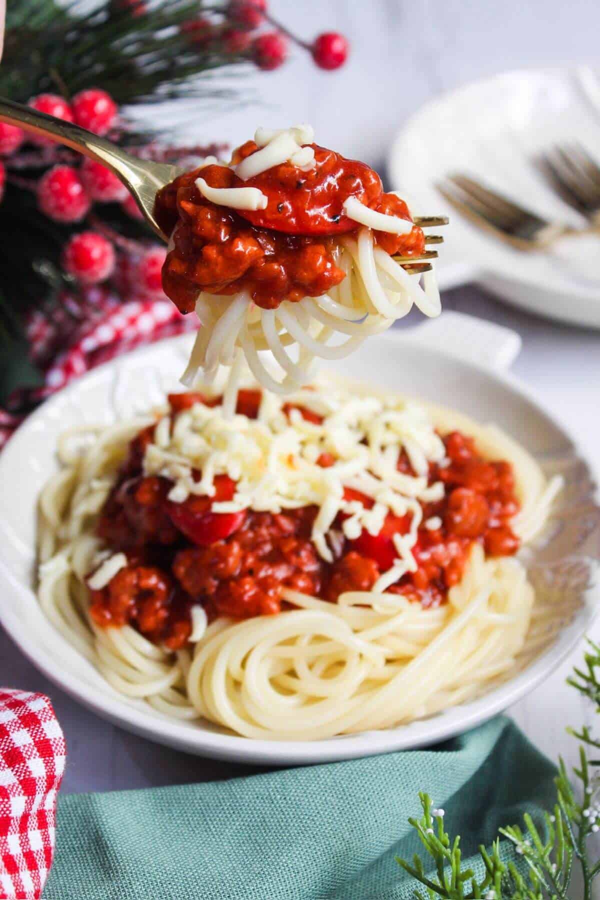 Spaghetti with meat sauce and cheese on a plate.