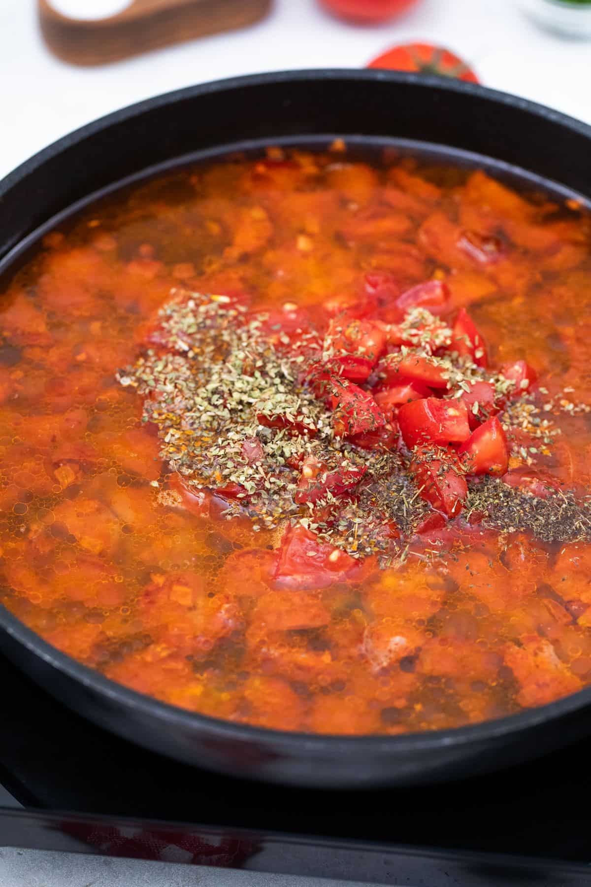 Stew base in a pan with seasonings.