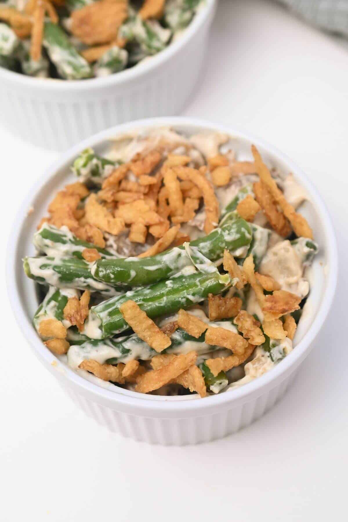 Green bean casserole in two white bowls.