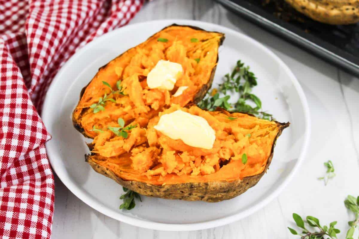 Sweet potatoes with butter and herbs on a plate.