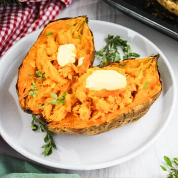 Sweet potatoes on a plate with butter and thyme.