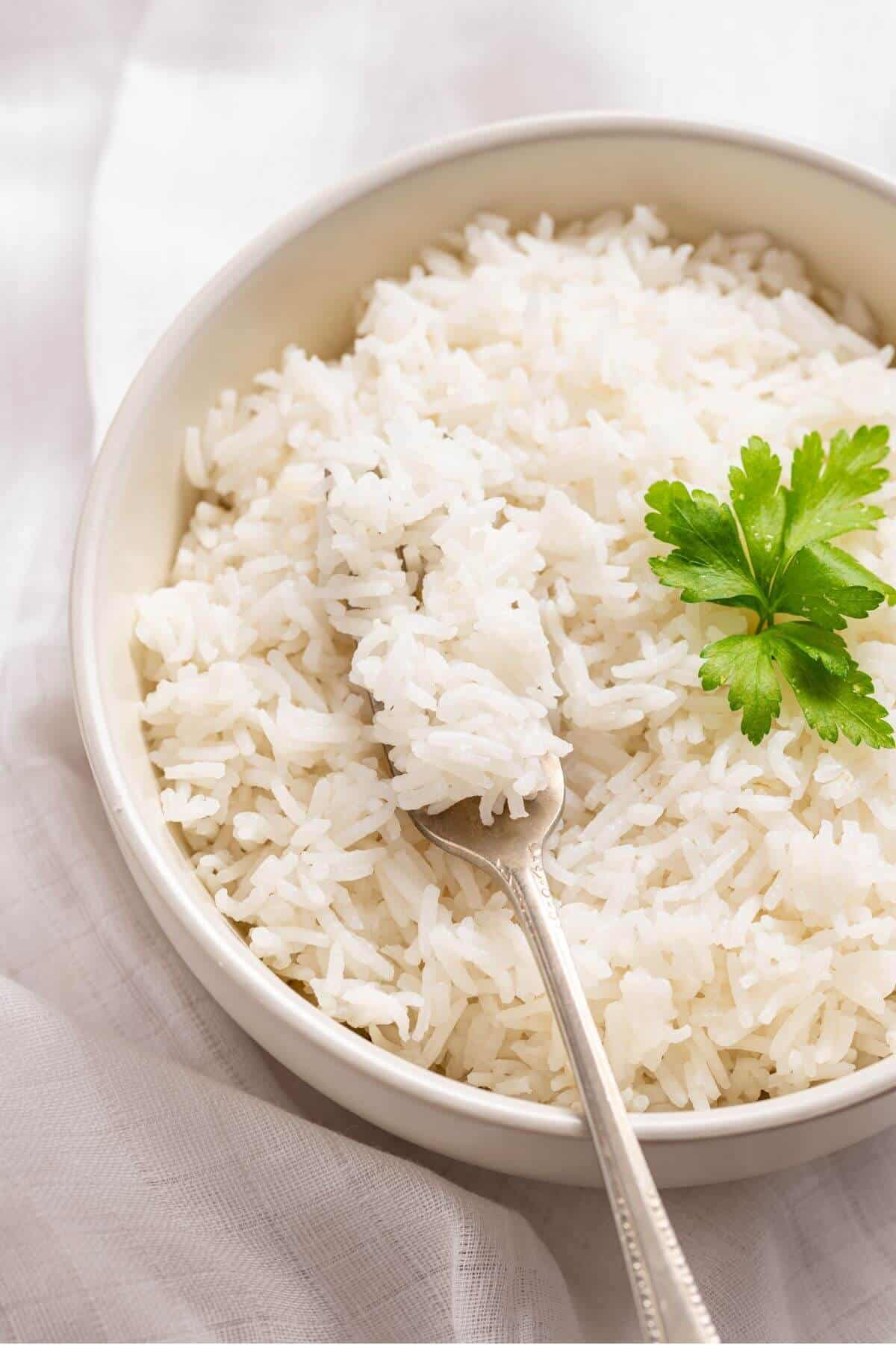 White rice in a bowl with a fork.