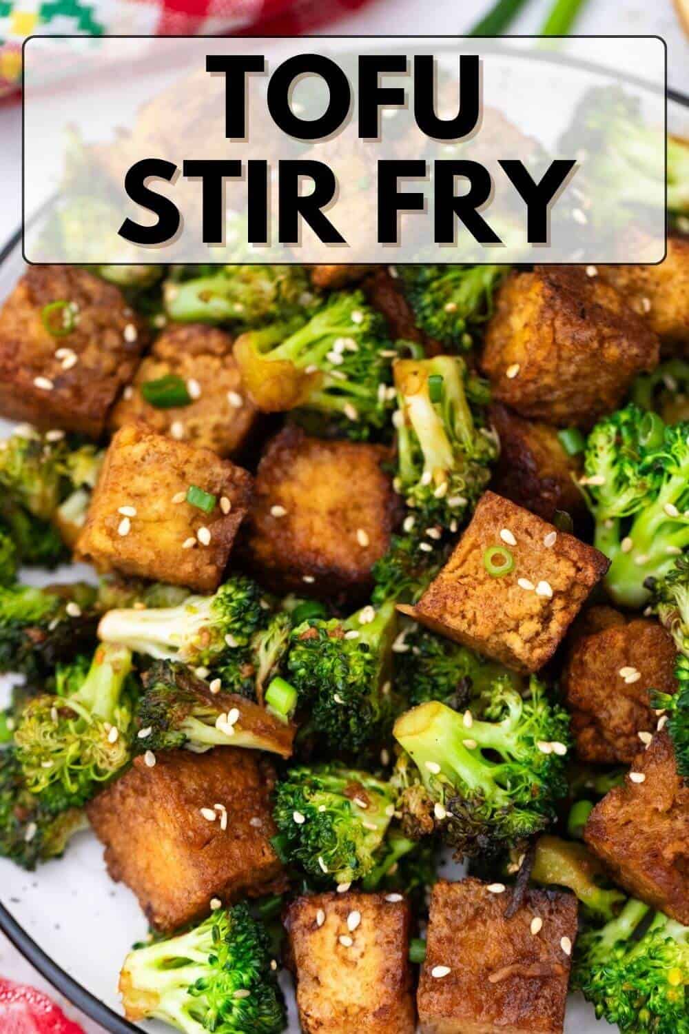 Tofu stir fry on a plate with broccoli.