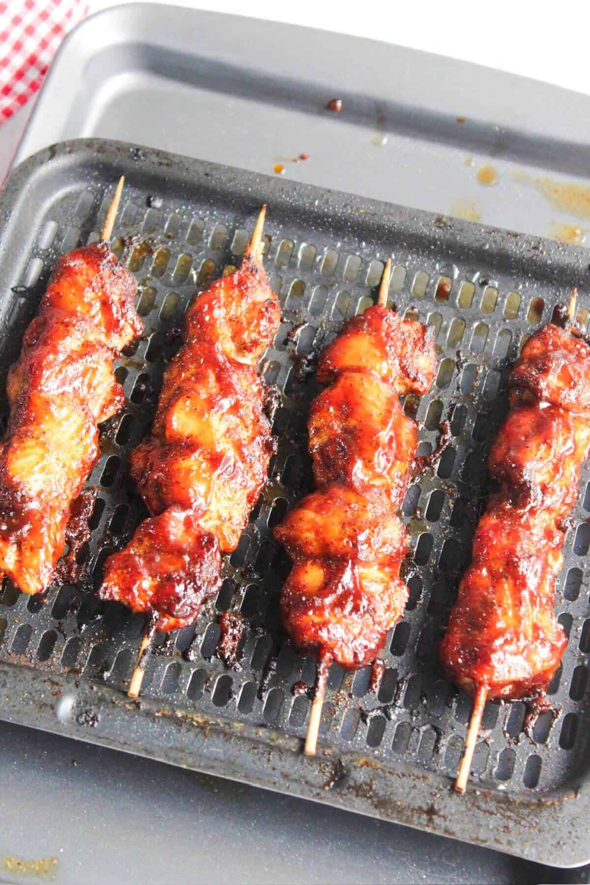 Bbq chicken skewers on an air fryer tray.