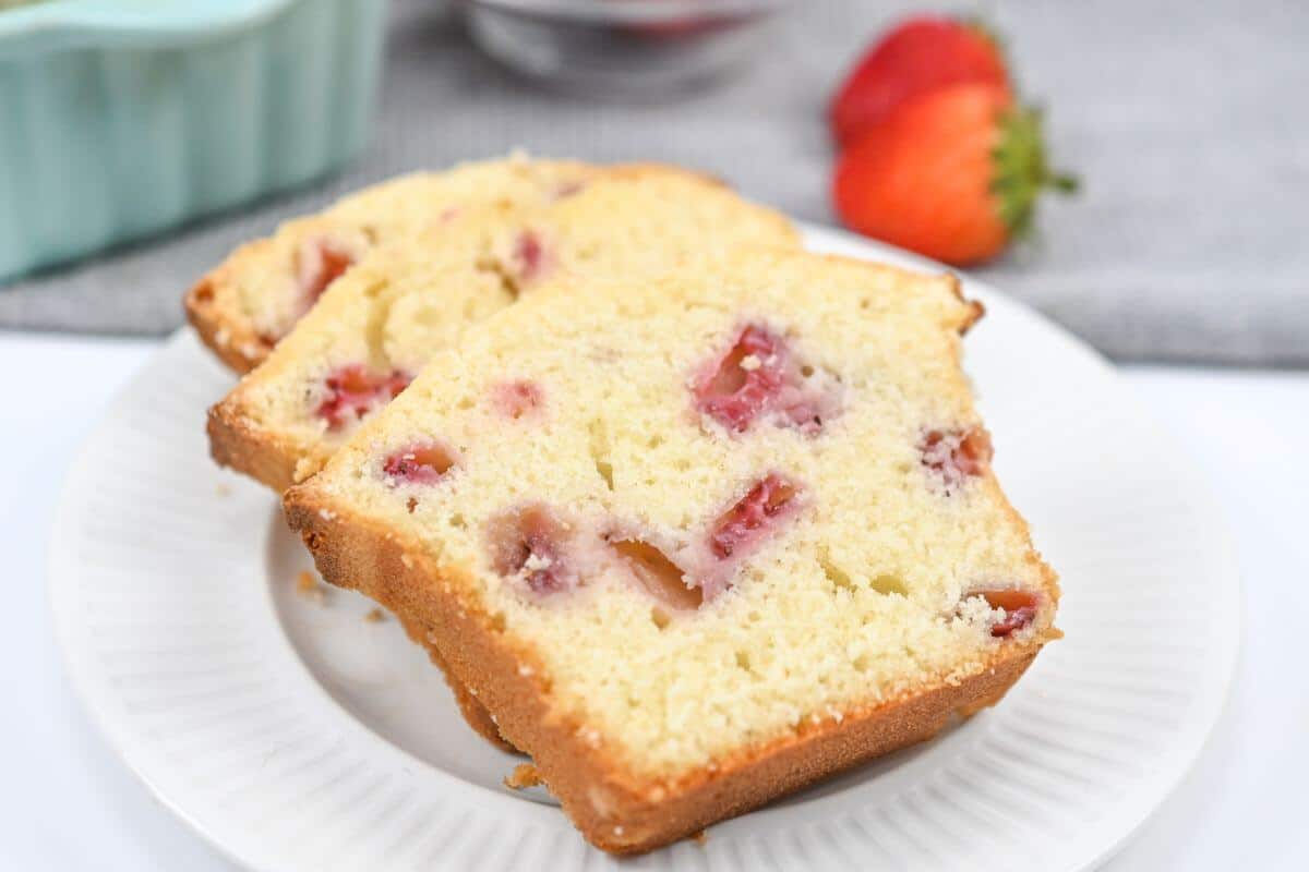 Three slices of strawberry bread on a white plate.