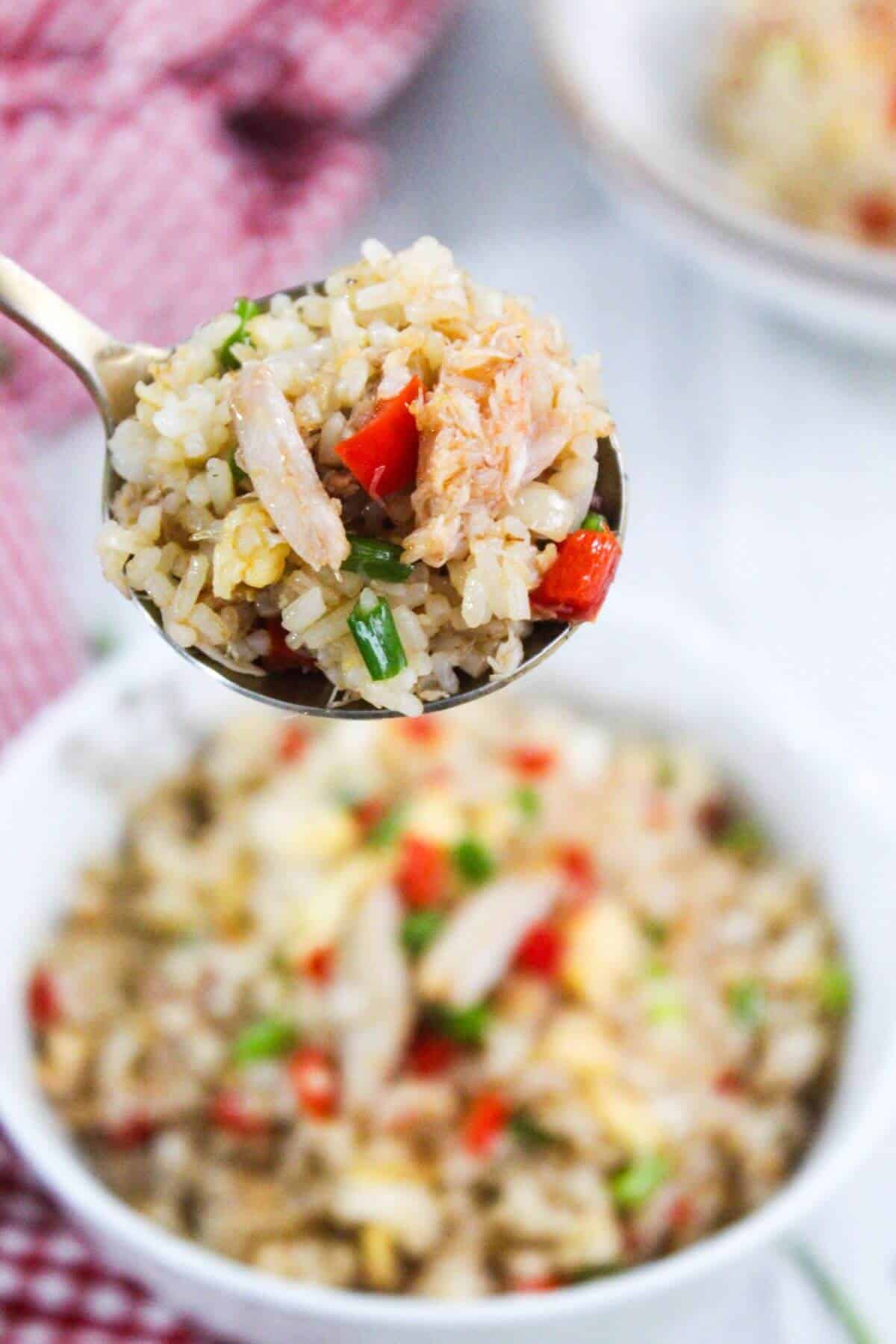 A spoonful of fried rice with crab and peppers.