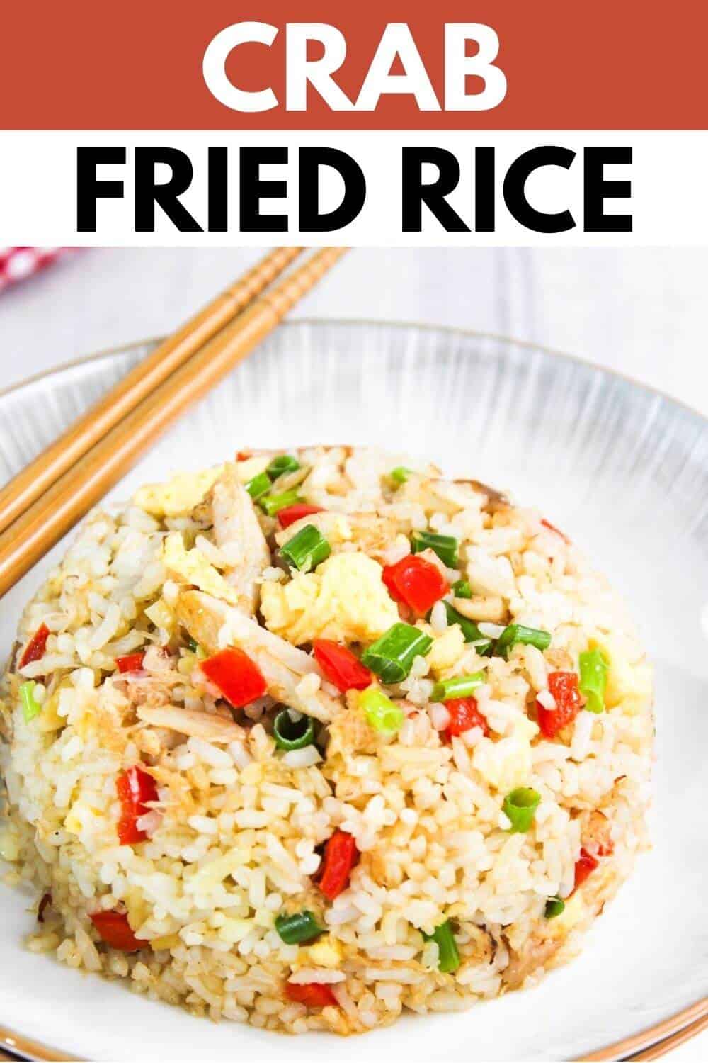Crab fried rice on a plate with chopsticks.