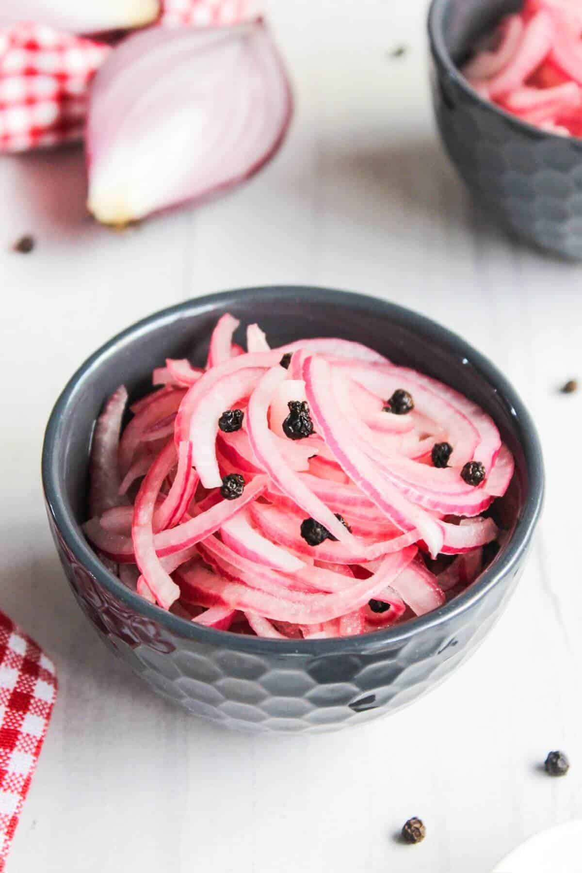 A bowl of sliced pickled red onions.