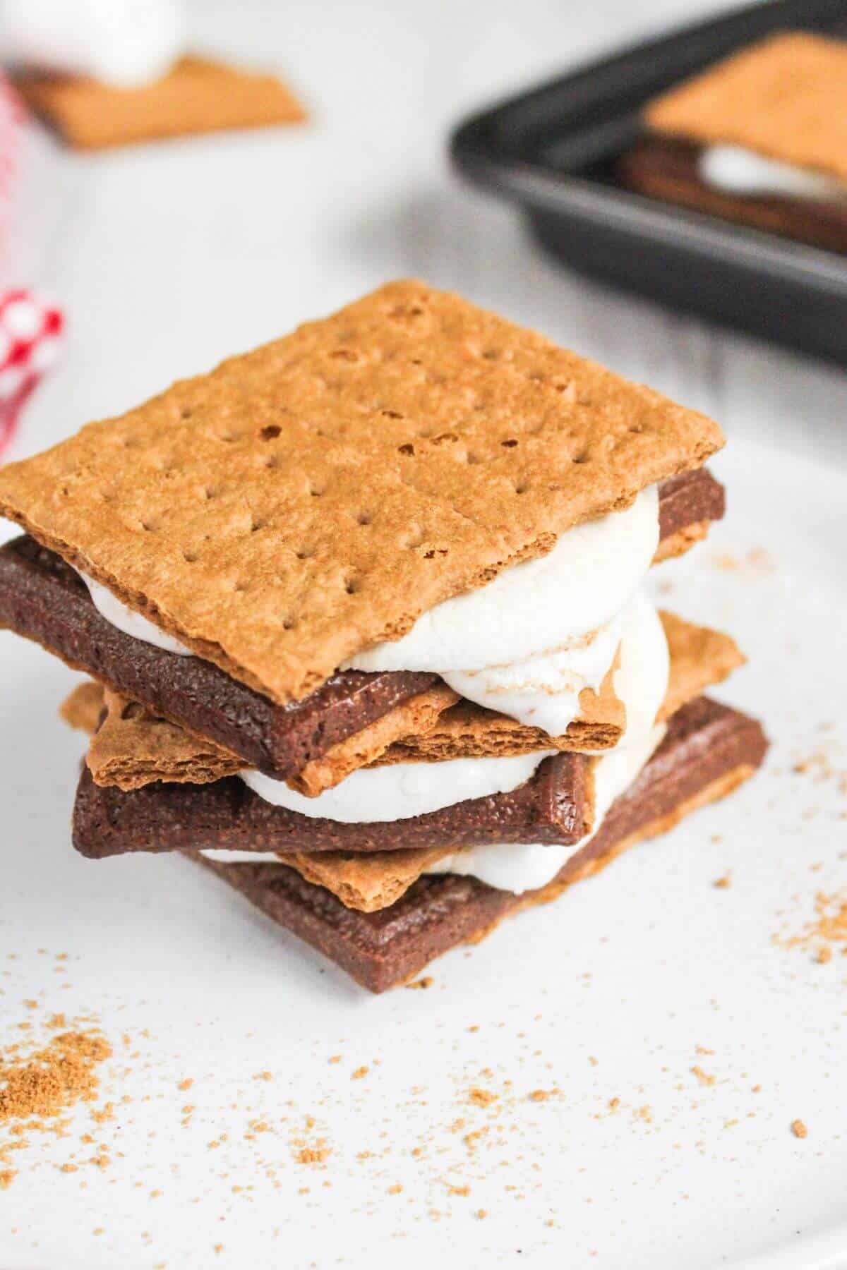 A stack of air fryer s'mores on a white plate.