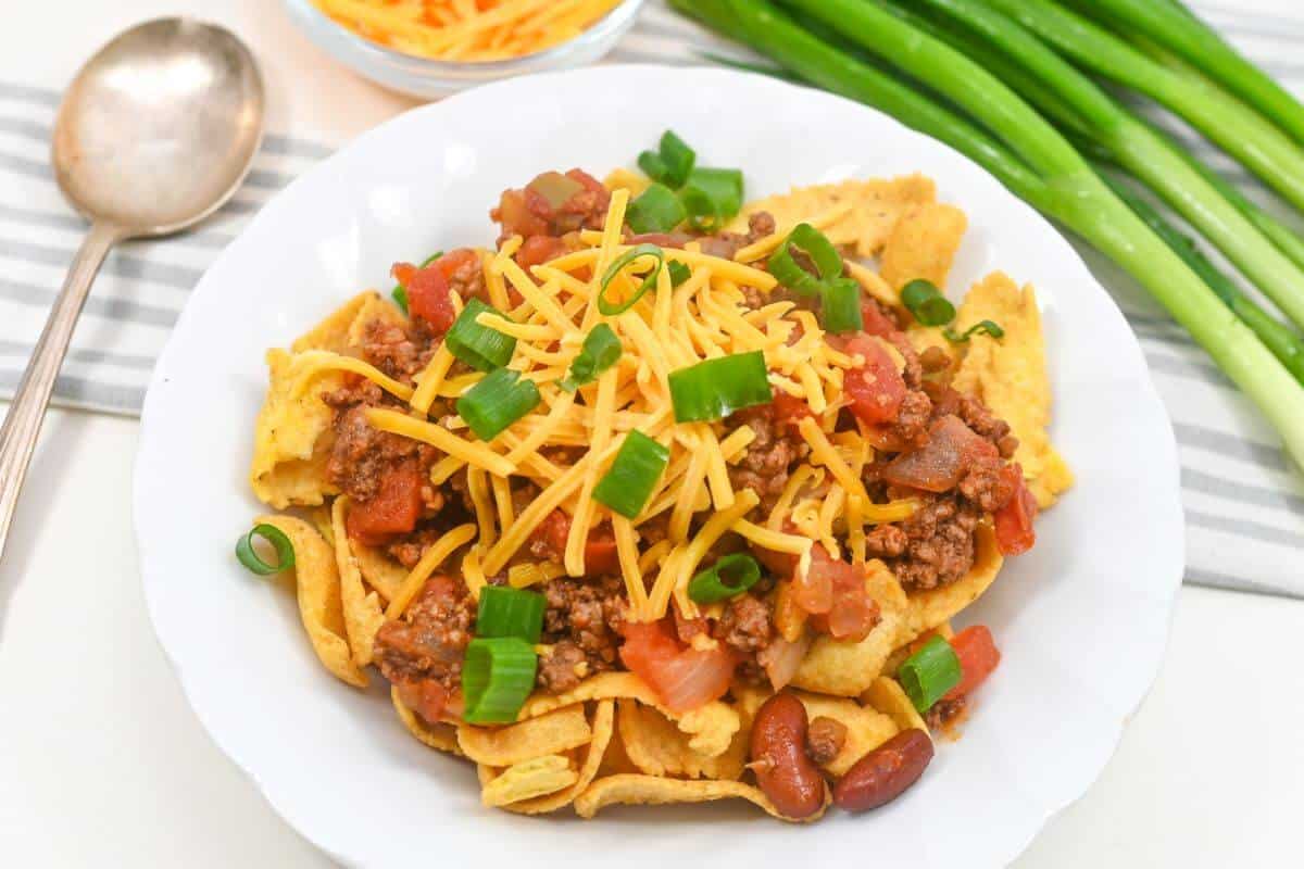 A plate of Fritos topped with chili.