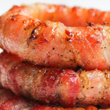Stack of bacon wrapped onion rings.