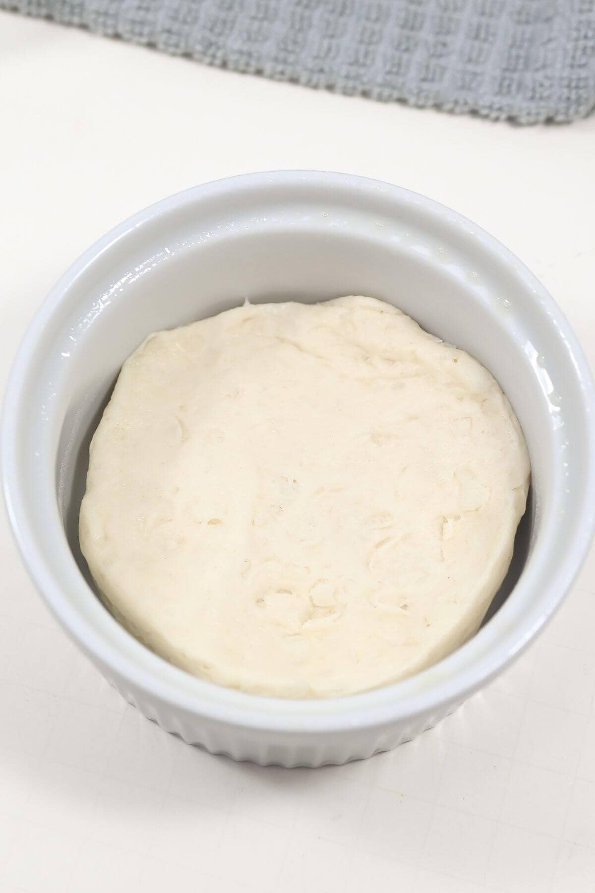 Biscuit dough in a white ceramic bowl.