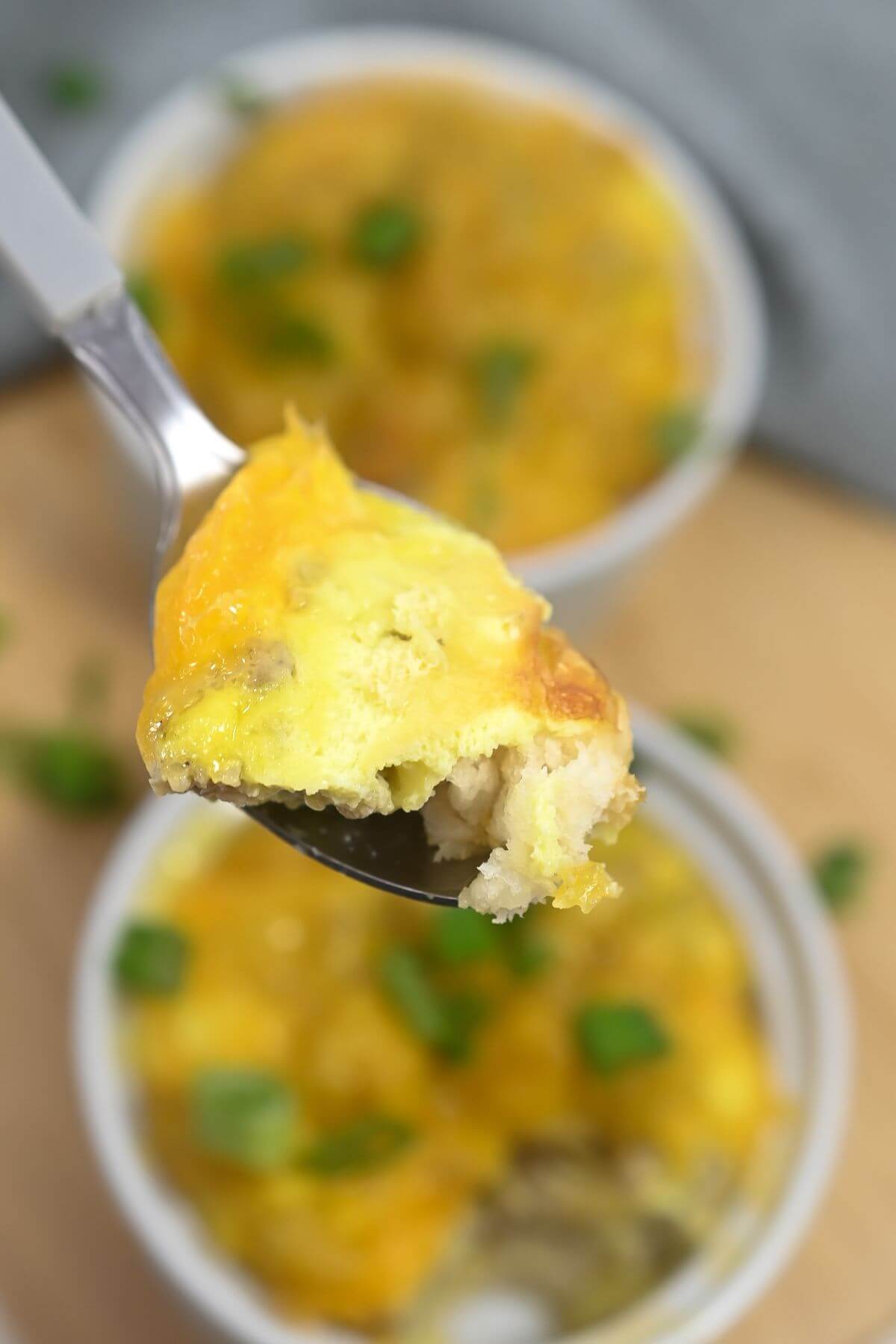 Spoon of biscuit egg casserole.