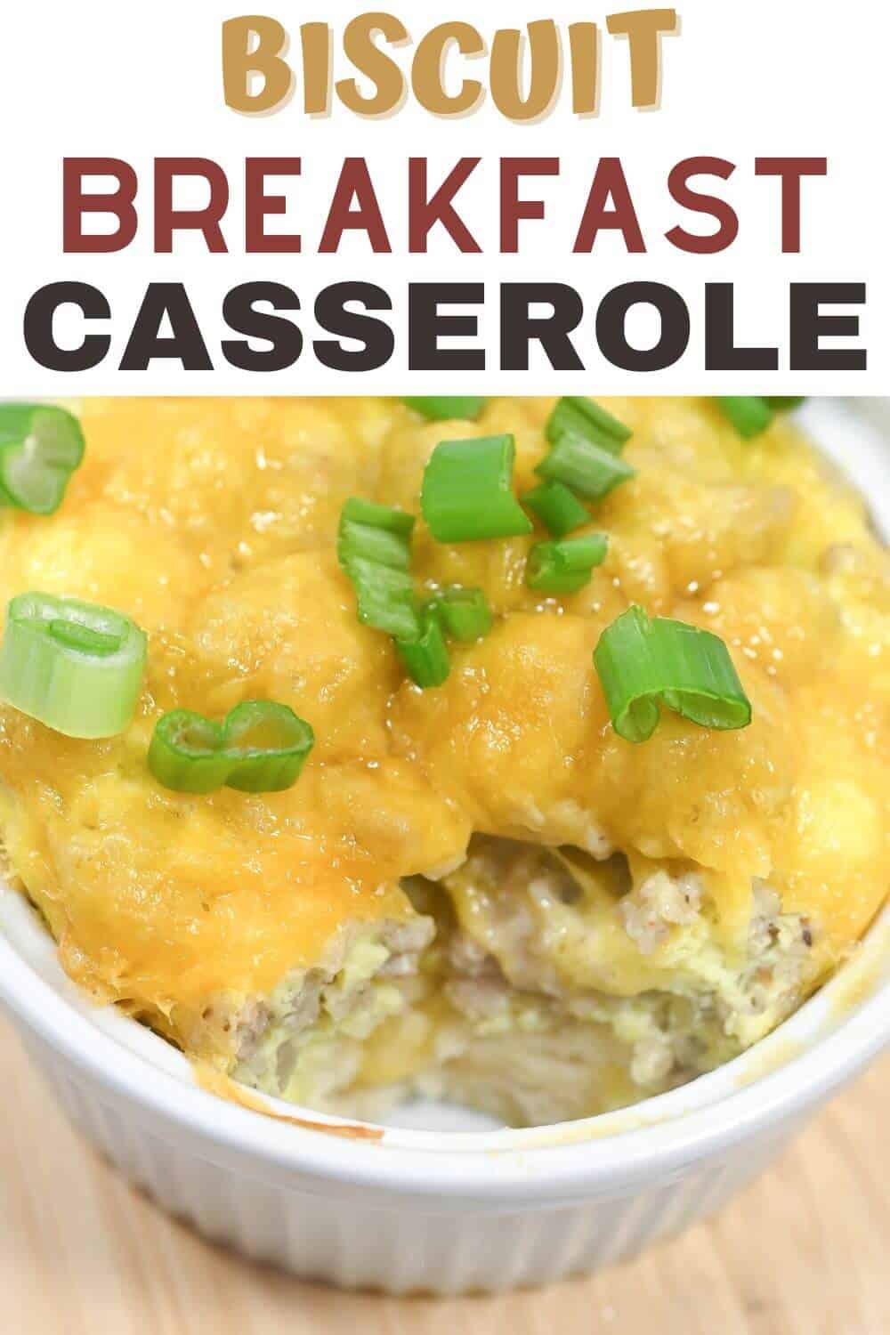 A cheesy biscuit breakfast casserole topped with sliced green onions.