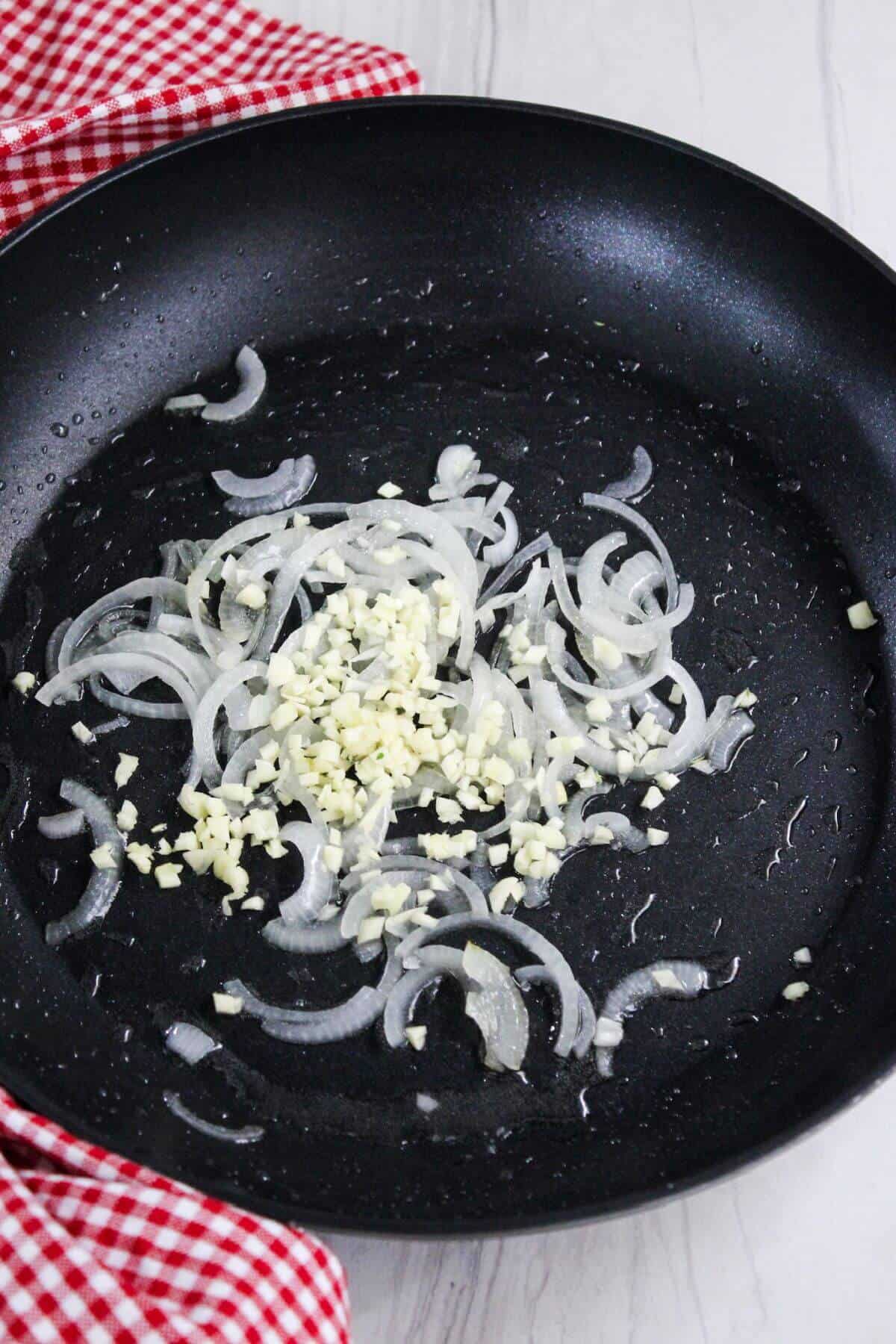 Fried onions and garlic in a frying pan.