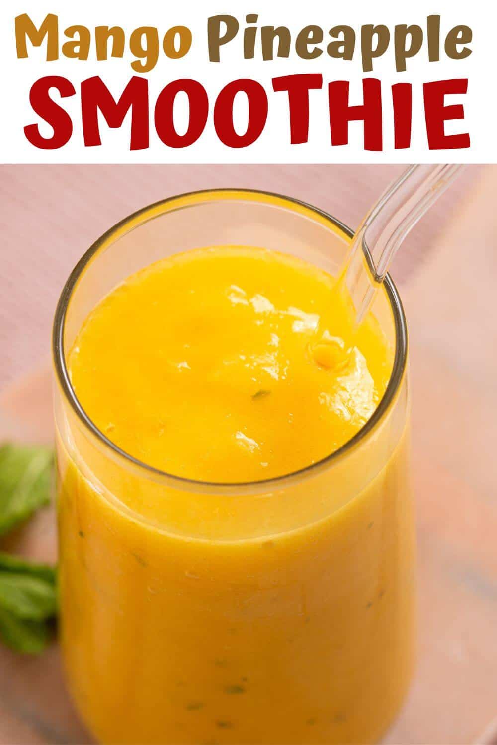 A close-up of a glass filled with mango pineapple smoothie with a glass straw on a light background. Text above reads "Mango Pineapple Smoothie.