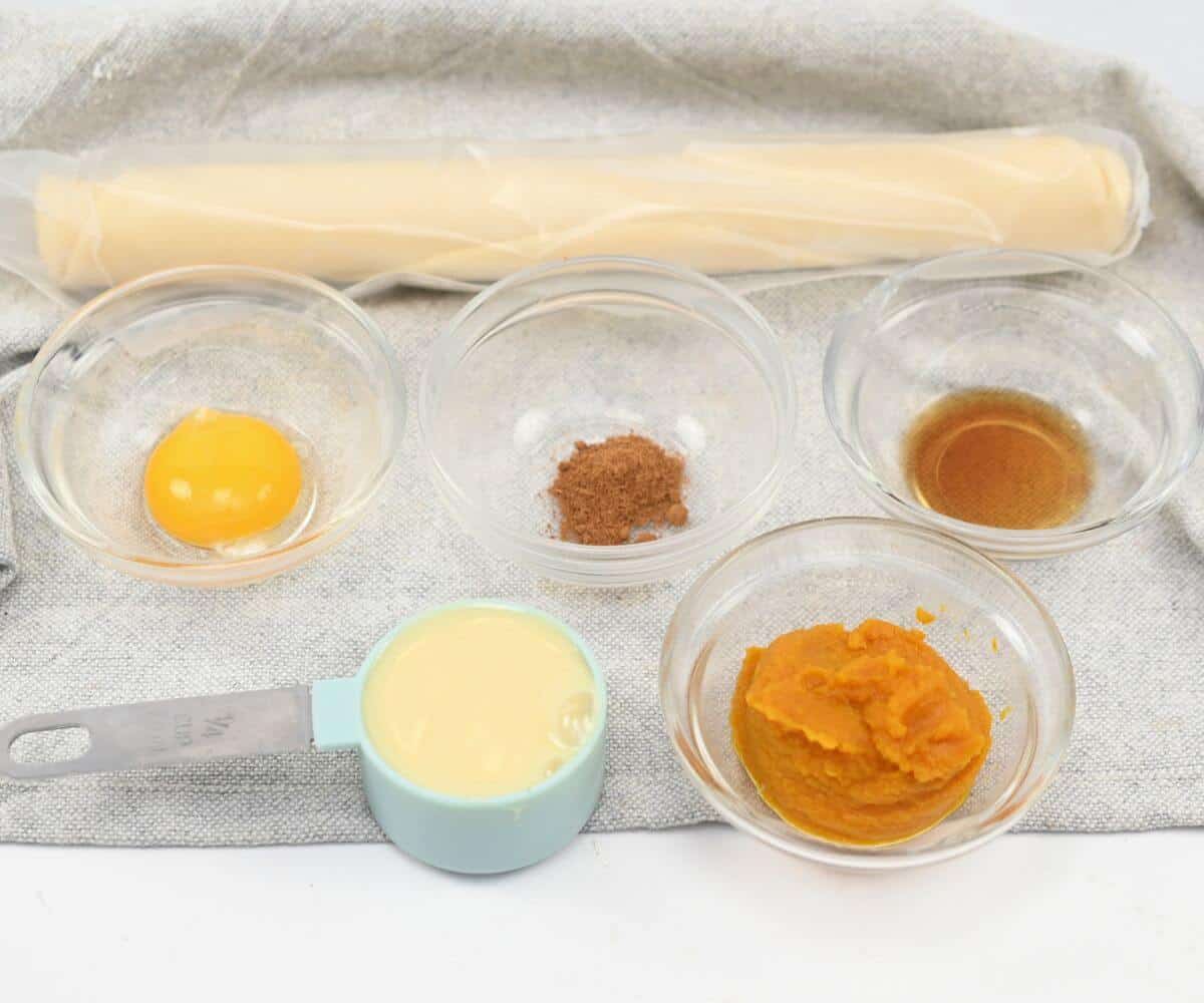 Pumpkin pie ingredients on a white towel.