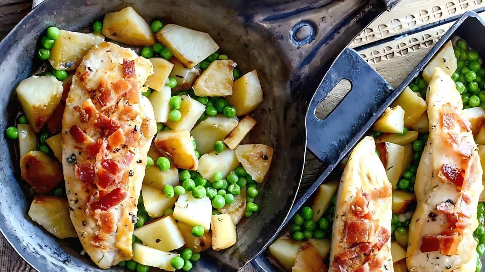 Chicken breast topped with bacon, served in a skillet with roasted potatoes and green peas.