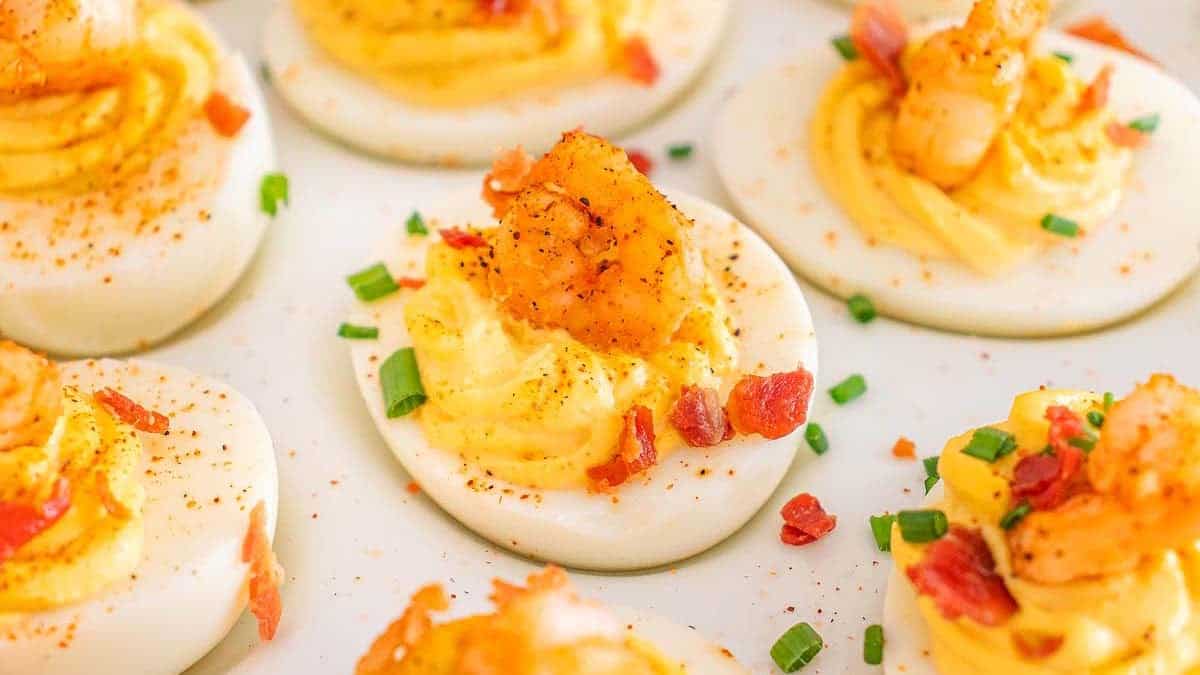 Deviled eggs with cajub shrimp on the top.