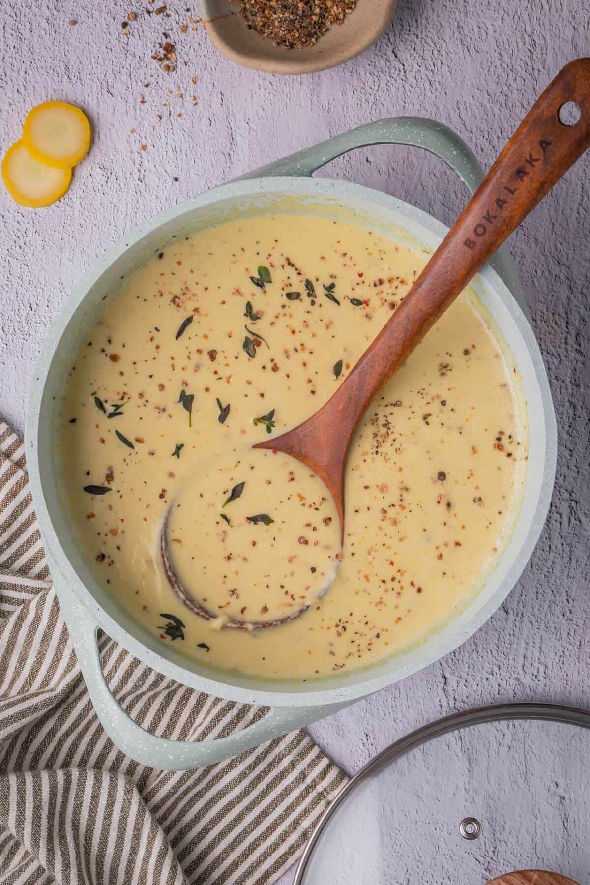 Warm yellow squash soup in a cozy pot