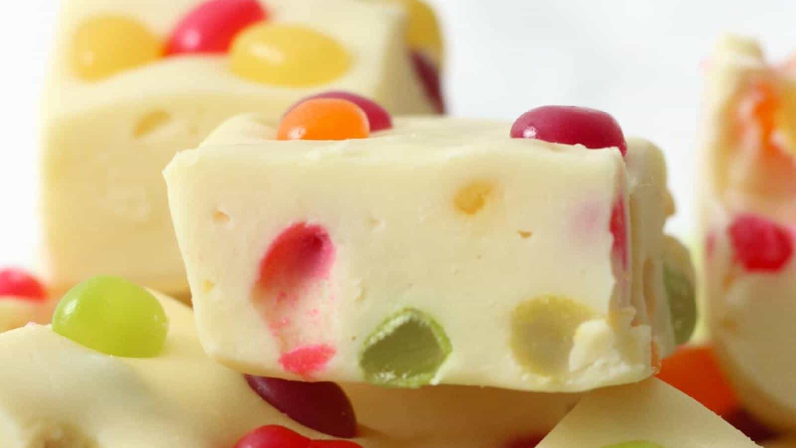 Close-up of white fudge squares with colorful jelly beans embedded inside and on top.